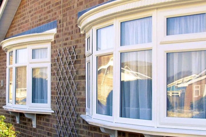 White bow window on a rendered house
