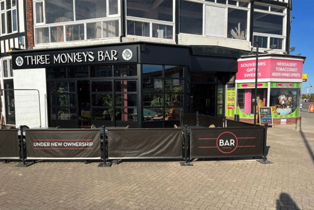 Black aluminium shopfront and glazing fitted to a seafront bar