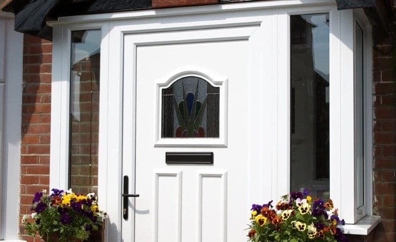 White front door with a decorative glazed panel